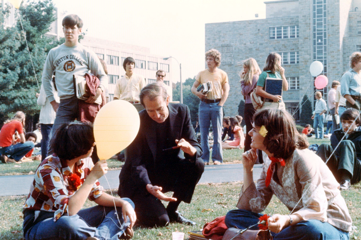 Rev. J. Donald Monan, S.J., 24th President and First Chancellor of Boston College, chats with students in the former “Dustbowl,” 1970s. 
